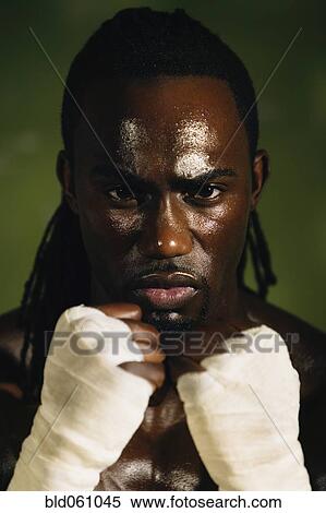Stock Photography - African male boxer with wrapped hands. Fotosearch