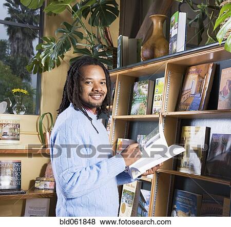 African man holding book View Large Photo Image Stock Photo - African man holding book. Fotosearch