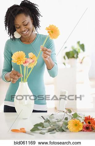 African woman arranging flowers View Large Photo Image Stock Photo - African woman arranging flowers. Fotosearch