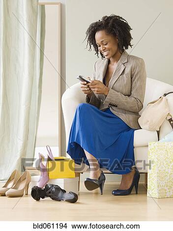 African woman dialing cell phone View Large Photo Image Picture - African woman dialing cell phone. Fotosearch