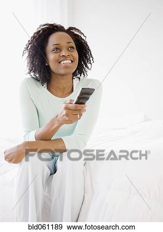 African woman pointing remote control View Large Photo Image Stock Photo - African woman pointing remote control. Fotosearch