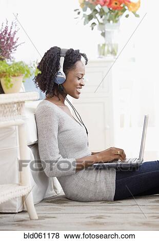 African woman typing on laptop View Large Photo Image Stock Photo - African woman typing on laptop. Fotosearch
