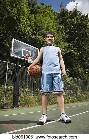 Stock Photography - Asian boy holding basketball. Fotosearch