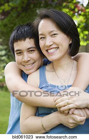 Asian boy hugging mother View Large Photo Image Stock Image - Asian boy hugging mother. Fotosearch