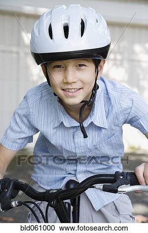 Stock Image - Asian boy riding bicycle. Fotosearch