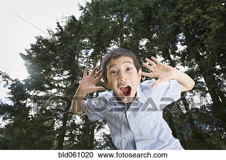Asian boy yelling outdoors View Large Photo Image Stock Image - Asian boy yelling outdoors. Fotosearch