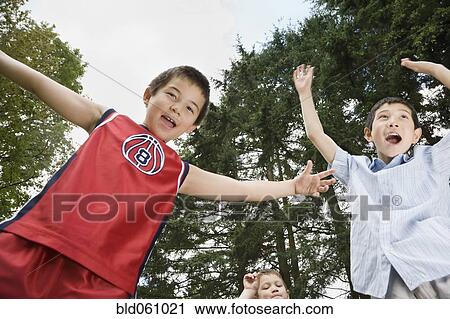 Asian brothers cheering outdoors View Large Photo Image Stock Image - Asian brothers cheering outdoors. Fotosearch