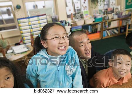 Stock Photo - Asian children and father in classroom. Fotosearch