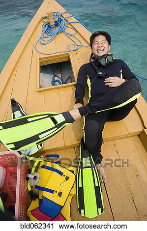 Asian man in scuba gear on boat deck View Large Photo Image Stock Image - Asian man in scuba gear on boat deck. Fotosearch