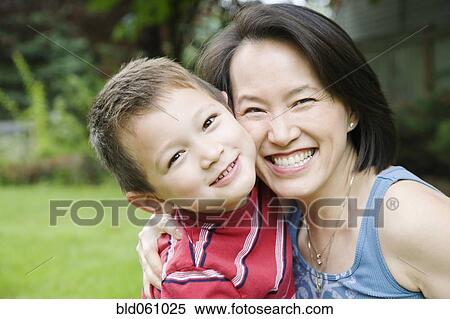 Stock Photography - Asian mother and son hugging. Fotosearch