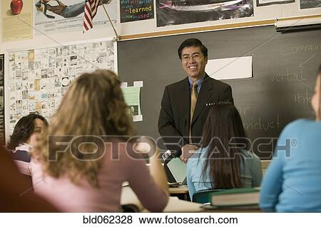 Asian teacher talking to students in classroom View Large Photo Image Stock Photo - Asian teacher talking to students in classroom. Fotosearch