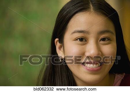 Stock Image - Asian teenage girl smiling. Fotosearch