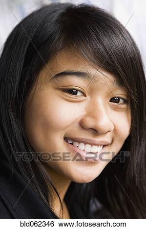 Stock Photograph - Asian teenage girl smiling. Fotosearch