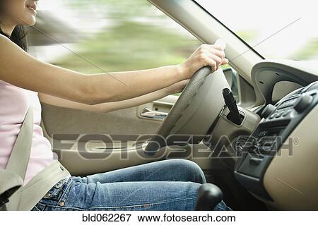 Stock Photo - Asian teenager driving car. Fotosearch