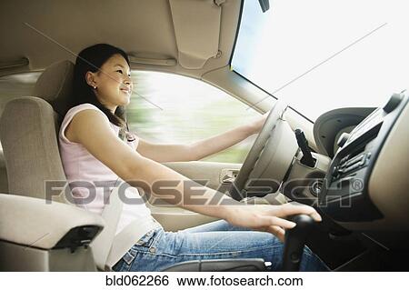 Stock Photograph - Asian teenager driving car. Fotosearch
