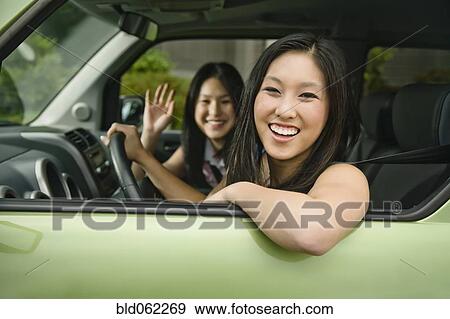 Stock Photo - Asian teenagers driving in car. Fotosearch