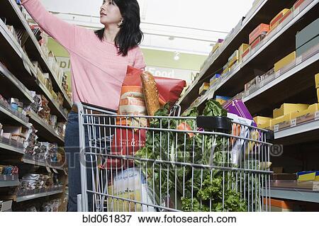 Asian woman grocery shopping View Large Photo Image Stock Photo - Asian woman grocery shopping. Fotosearch