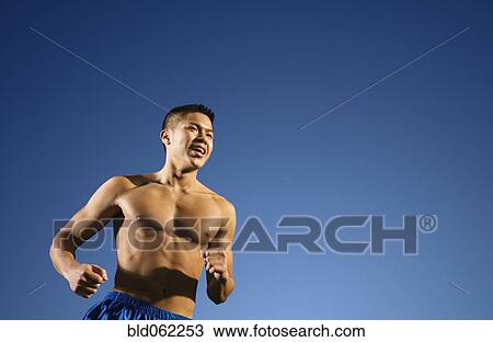Bare chested Asian man jogging View Large Photo Image Stock Image - Bare chested Asian man jogging. Fotosearch