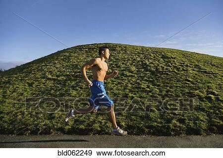 Bare chested Asian man jogging View Large Photo Image Stock Photo - Bare chested Asian man jogging. Fotosearch