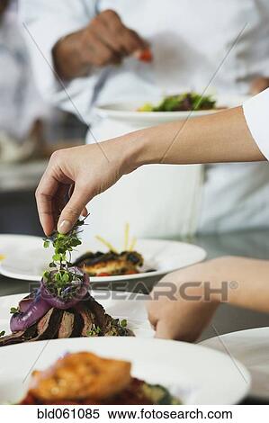 Chef putting garnish on plate of food View Large Photo Image Stock Photography - Chef putting garnish on plate of food. Fotosearch