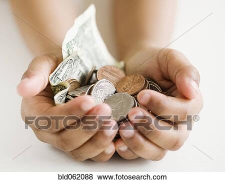 Stock Photo - Close up of mixed race girl holding money. Fotosearch