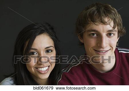 Stock Photo - Close up of Multi-ethnic couple smiling. Fotosearch