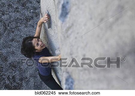 Stock Photography - Filipino woman rock climbing. Fotosearch