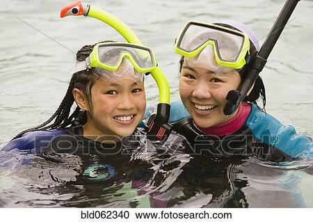 Stock Image - Friends snorkeling together. Fotosearch