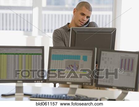 Stock Photo - Hispanic businessman talking on telephone. Fotosearch