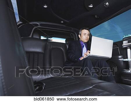 Stock Image - Hispanic businessman typing on laptop. Fotosearch