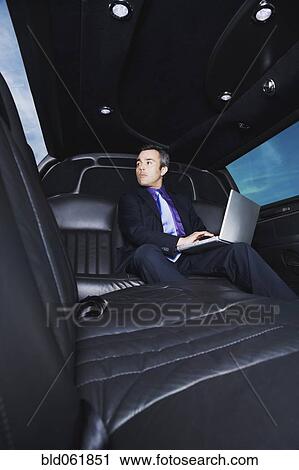 Stock Image - Hispanic businessman typing on laptop. Fotosearch