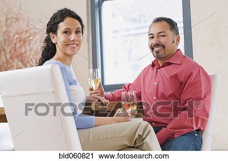 Stock Image - Hispanic couple drinking wine. Fotosearch