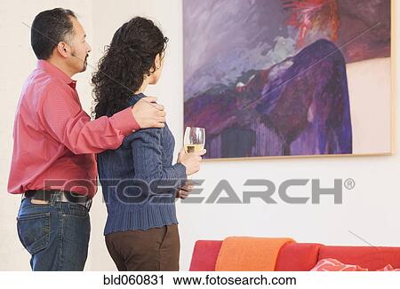 Hispanic couple looking at artwork View Large Photo Image Stock Image - Hispanic couple looking at artwork. Fotosearch