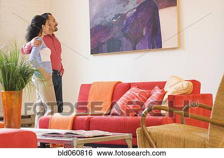 Stock Photograph - Hispanic couple looking at artwork. Fotosearch