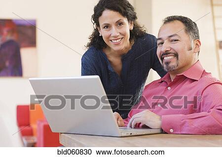 Hispanic couple next to laptop View Large Photo Image Stock Image - Hispanic couple next to laptop. Fotosearch