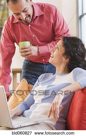 Stock Photo - Hispanic couple smiling at each other. Fotosearch