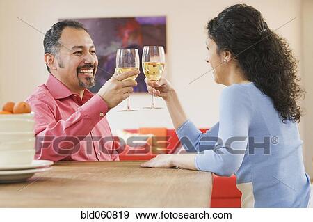 Hispanic couple toasting with wine View Large Photo Image Stock Photo - Hispanic couple toasting with wine. Fotosearch