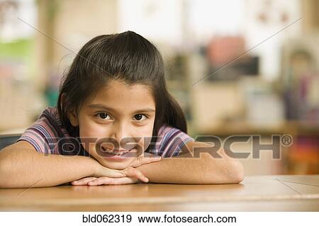 Hispanic girl laying her head on arms View Large Photo Image Stock Photo - Hispanic girl laying her head on arms. Fotosearch