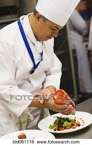 Hispanic male chef garnishing plate of food View Large Photo Image Stock Photograph - Hispanic male chef garnishing plate of food. Fotosearch