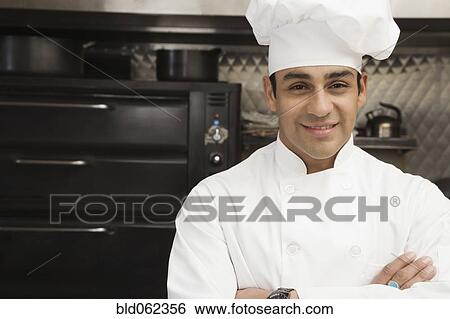 Stock Photograph - Hispanic male chef with arms crossed. Fotosearch