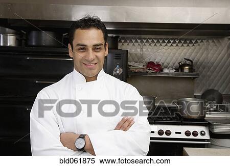 Stock Photography - Hispanic male chef with arms crossed. Fotosearch