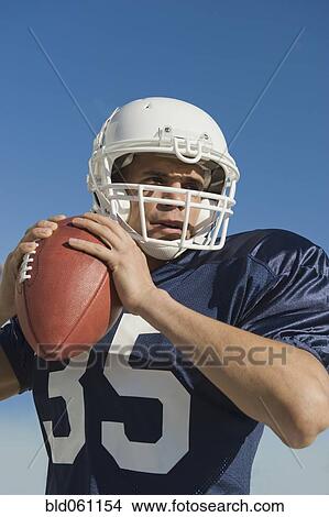 Hispanic male football player throwing ball View Large Photo Image Picture - Hispanic male football player throwing ball. Fotosearch