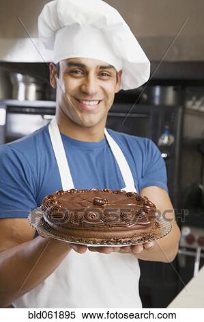 Hispanic male pastry chef holding cake View Large Photo Image Stock Photography - Hispanic male pastry chef holding cake. Fotosearch
