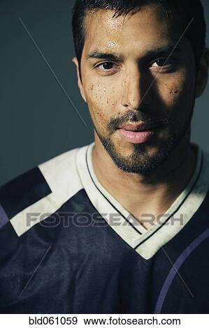 Stock Photo - Hispanic male soccer player with dirt on face. Fotosearch