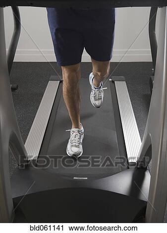 Hispanic man running on treadmill View Large Photo Image Stock Image - Hispanic man running on treadmill. Fotosearch