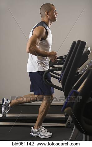 Hispanic man running on treadmill View Large Photo Image Stock Image - Hispanic man running on treadmill. Fotosearch