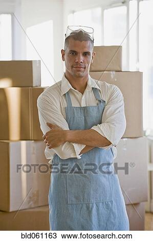 Stock Image - Hispanic man wearing apron and protective eyewear. Fotosearch