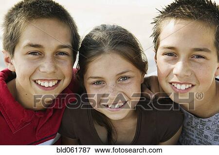 Hispanic twin brothers and sister hugging View Large Photo Image Stock Photo - Hispanic twin brothers and sister hugging. Fotosearch