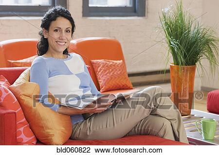Hispanic woman reading magazine View Large Photo Image Stock Image - Hispanic woman reading magazine. Fotosearch