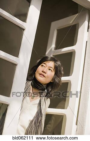 Japanese woman looking out french doors View Large Photo Image Stock Image - Japanese woman looking out french doors. Fotosearch